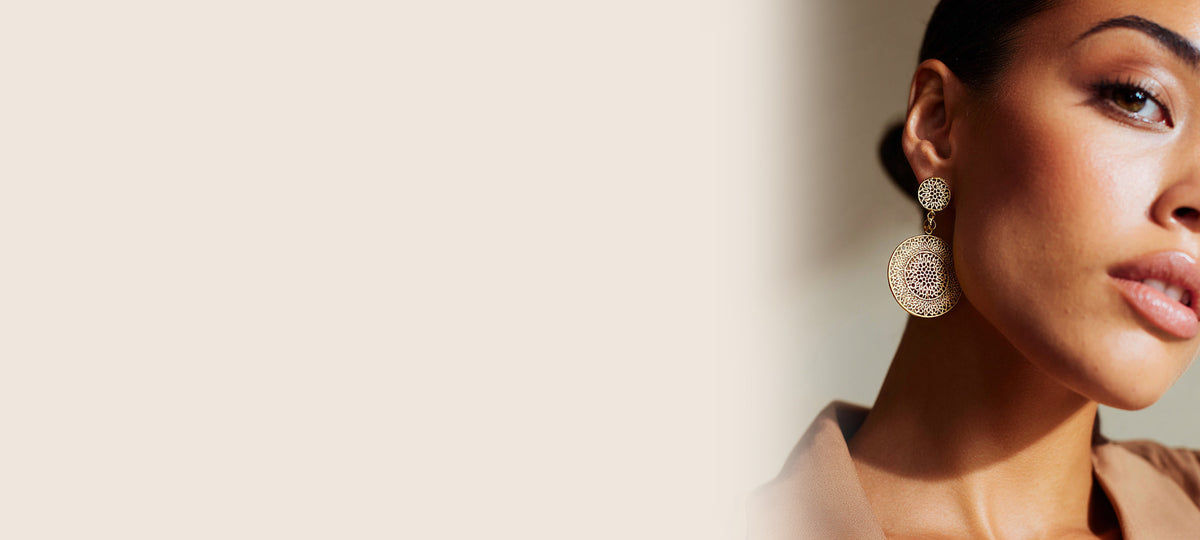 Model wearing AVENUE FALLS earrings